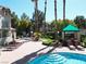 Inviting community pool and spa with lush landscaping, towering palms, and BBQ area at 75 N Valle Verde Dr # 1822, Henderson, NV 89074