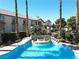 Resort-style community pool with a stone waterfall feature and poolside seating at 75 N Valle Verde Dr # 1822, Henderson, NV 89074
