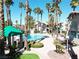This pool features mature palm trees, lounge chairs, and shaded cabanas at 75 N Valle Verde Dr # 1822, Henderson, NV 89074