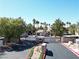 Community entrance gate surrounded by trees, shrubs, and palm trees at 75 N Valle Verde Dr # 1822, Henderson, NV 89074