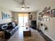 Comfortable living room with a ceiling fan, wood flooring, and sliding door access to balcony at 75 N Valle Verde Dr # 1822, Henderson, NV 89074