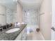 Bathroom with marble countertop, sleek white cabinetry, and modern shower at 778 Oakmont Ave # 312, Las Vegas, NV 89109