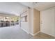Neutral open-concept living room features a pass-through to the kitchen and bright front door entry at 778 Oakmont Ave # 312, Las Vegas, NV 89109