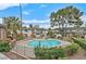 Aerial view of community pool with chairs, landscaping, buildings, and a backdrop featuring Las Vegas skyline at 778 Oakmont Ave # 312, Las Vegas, NV 89109