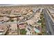 Aerial view showcasing a residential neighborhood with manicured lawns, pools, and roadways at 7825 Alameda Creek St, Las Vegas, NV 89113