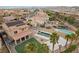 Aerial view of a private backyard with a sparkling pool, covered patio, lush lawn, and a sports court at 7825 Alameda Creek St, Las Vegas, NV 89113