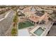 Gorgeous backyard featuring a sparkling pool and spa, a sport court, artificial grass and a patio at 7825 Alameda Creek St, Las Vegas, NV 89113