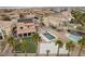 An aerial view of a backyard with a pool, spa, artificial grass, and palm trees at 7825 Alameda Creek St, Las Vegas, NV 89113