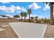 Concrete court area surrounded by desert landscaping and palm trees at 7825 Alameda Creek St, Las Vegas, NV 89113