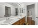 Bright bathroom features double sinks, wooden vanity, and wood-look flooring at 7825 Alameda Creek St, Las Vegas, NV 89113