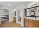 Bathroom featuring dual vanities, wood cabinets, and large mirrors at 7825 Alameda Creek St, Las Vegas, NV 89113