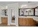 Bathroom featuring dual vanities, wood cabinets, and large mirrors at 7825 Alameda Creek St, Las Vegas, NV 89113