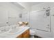 Bathroom with a vanity, framed mirror, toilet, and shower/tub combo enclosed by sliding glass doors at 7825 Alameda Creek St, Las Vegas, NV 89113