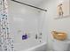 This bathroom features a shower over tub and tiled walls at 7825 Alameda Creek St, Las Vegas, NV 89113