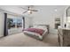 Bright bedroom with a modern bed frame, large window, and neutral carpet at 7825 Alameda Creek St, Las Vegas, NV 89113