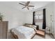 Cozy bedroom with modern platform bed, ceiling fan, and large window at 7825 Alameda Creek St, Las Vegas, NV 89113