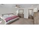 Bright bedroom with neutral carpet, a ceiling fan, and a wooden bed frame at 7825 Alameda Creek St, Las Vegas, NV 89113