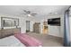 Spacious bedroom featuring neutral carpet, ceiling fan, and natural wood furniture at 7825 Alameda Creek St, Las Vegas, NV 89113