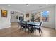 Elegant dining room with a modern table set and large windows providing natural light at 7825 Alameda Creek St, Las Vegas, NV 89113