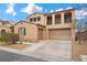 Inviting two-story home featuring a tile roof, balcony, desert landscaping, and a two-car garage at 7825 Alameda Creek St, Las Vegas, NV 89113