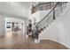 Bright entryway with an elegant staircase, tile flooring, and views of the dining area at 7825 Alameda Creek St, Las Vegas, NV 89113