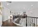 Second floor landing overlooking the living spaces with dark hardwood floors and wrought iron railings at 7825 Alameda Creek St, Las Vegas, NV 89113