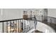 Second floor landing overlooking the living spaces with dark hardwood floors and wrought iron railings at 7825 Alameda Creek St, Las Vegas, NV 89113