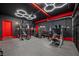 Finished home gym with honeycomb LED lighting, weight racks, and mirrored wall at 7825 Alameda Creek St, Las Vegas, NV 89113