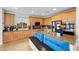 Beautiful kitchen with granite countertops, wood cabinets, and a large center island with seating at 7825 Alameda Creek St, Las Vegas, NV 89113