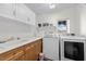 Well-equipped laundry room with a utility sink, washer, and dryer at 7825 Alameda Creek St, Las Vegas, NV 89113