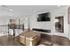 Second floor landing overlooking the living spaces with dark hardwood floors and access to balcony at 7825 Alameda Creek St, Las Vegas, NV 89113