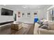 Comfortable living room with plush seating, a modern TV console, and bright windows at 7825 Alameda Creek St, Las Vegas, NV 89113