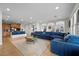 Bright, open living room featuring a large blue sectional sofa and plenty of natural light at 7825 Alameda Creek St, Las Vegas, NV 89113