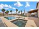 This backyard features a lovely pool, spa, and outdoor kitchen at 7825 Alameda Creek St, Las Vegas, NV 89113