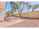 Spacious backyard with brick patio, mature trees, and a privacy wall offering a tranquil outdoor space at 92 Sea Holly Way, Henderson, NV 89074