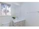 Half bath featuring a modern single vanity and window at 92 Sea Holly Way, Henderson, NV 89074