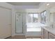 Bright bathroom with a glass shower, tub, and double windows at 92 Sea Holly Way, Henderson, NV 89074