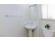 Bathroom featuring a pedestal sink, white walls and a window at 92 Sea Holly Way, Henderson, NV 89074