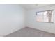 Well-lit bedroom with neutral carpet and view from window at 92 Sea Holly Way, Henderson, NV 89074