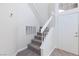 Bright entryway with carpeted stairs, white railings and trim, and modern front door at 92 Sea Holly Way, Henderson, NV 89074