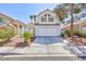 Charming two-story home with a well-maintained lawn and a two-car garage at 92 Sea Holly Way, Henderson, NV 89074