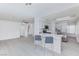 Open kitchen with stainless appliances, white cabinets, and counter seating at 92 Sea Holly Way, Henderson, NV 89074