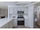 Kitchen with stainless appliances, white cabinets and white countertops at 92 Sea Holly Way, Henderson, NV 89074