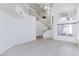 Bright living room with light wood floors, a staircase, and large windows at 92 Sea Holly Way, Henderson, NV 89074