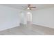 Bright living room with light wood flooring, white walls and archway at 92 Sea Holly Way, Henderson, NV 89074