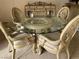 Formal dining room showcases a glass-topped table with ornate chairs and matching buffet at 9301 Harrow Rock St, Las Vegas, NV 89143