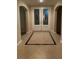 Inviting entryway with neutral tile flooring, elegant front doors, and ample natural light at 9301 Harrow Rock St, Las Vegas, NV 89143