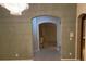 Hallway with archway leading to sitting area with a window and furniture at 9301 Harrow Rock St, Las Vegas, NV 89143