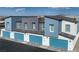 Eye-catching aerial view showcasing modern townhomes with blue garage doors and contrasting facades at 9451 Calm Stream Ave # Lot 81, Las Vegas, NV 89178