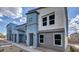 Modern townhomes showcasing contemporary design with a stone walkway, landscaping, and a blue and gray color scheme at 9451 Calm Stream Ave # Lot 81, Las Vegas, NV 89178